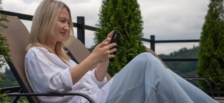 A woman sitting on an outdoor lounge chair